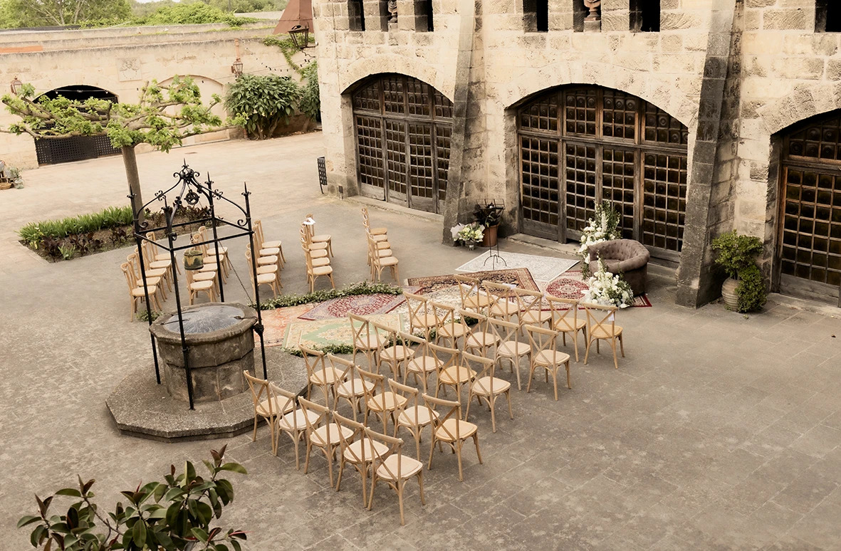 Wedding ceremony setup at Finca Gordiola Mallorca with chairs and floral decorations.