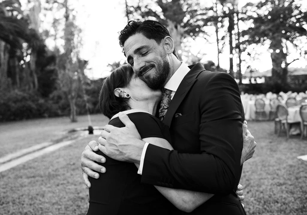 el novio abrazado a su madre amigas en su boda fotógrafo de bodas en Mallorca – Inma del Valle –