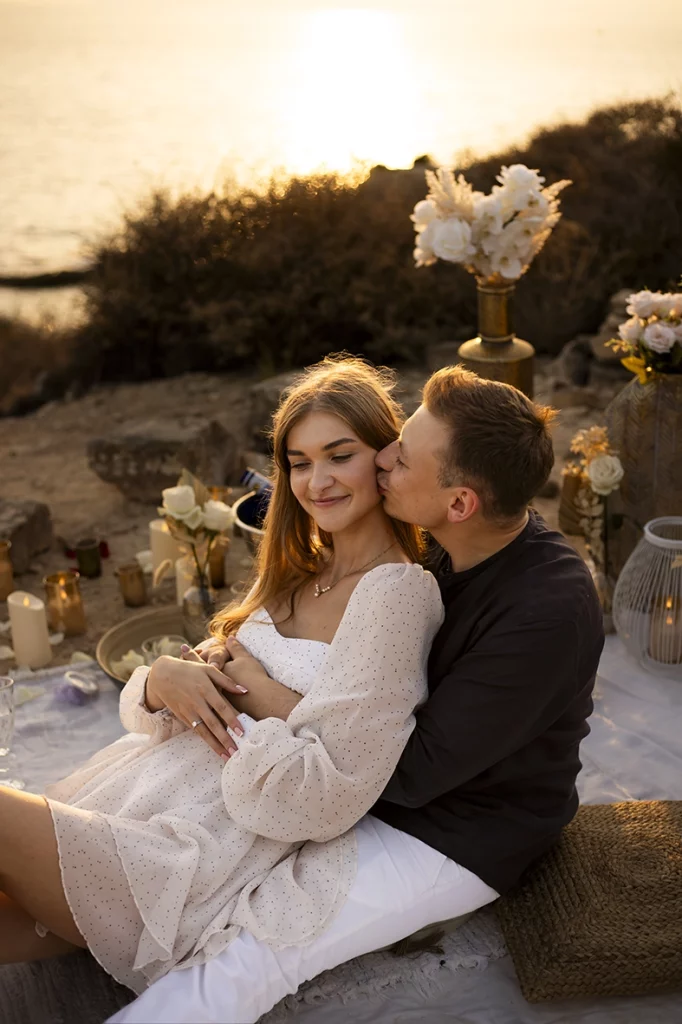 Couple embracing as he tenderly kisses his fiancée after the proposal in Mallorca, captured by a photographer for proposals in Mallorca.