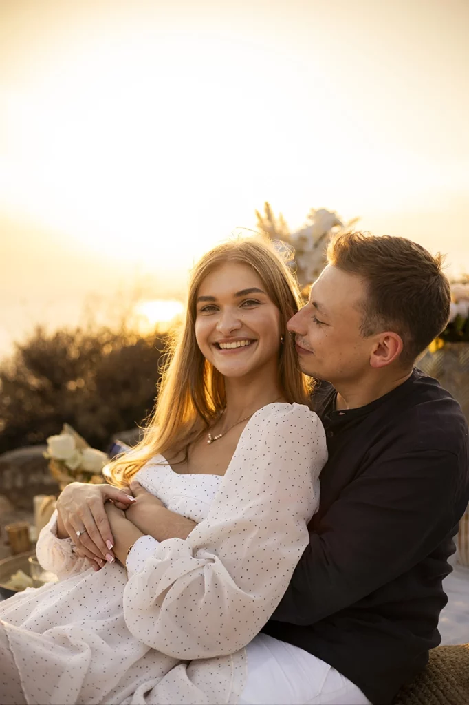 Smiling couple enjoying the sunset after their proposal in Mallorca, captured by a photographer for proposals in Mallorca.