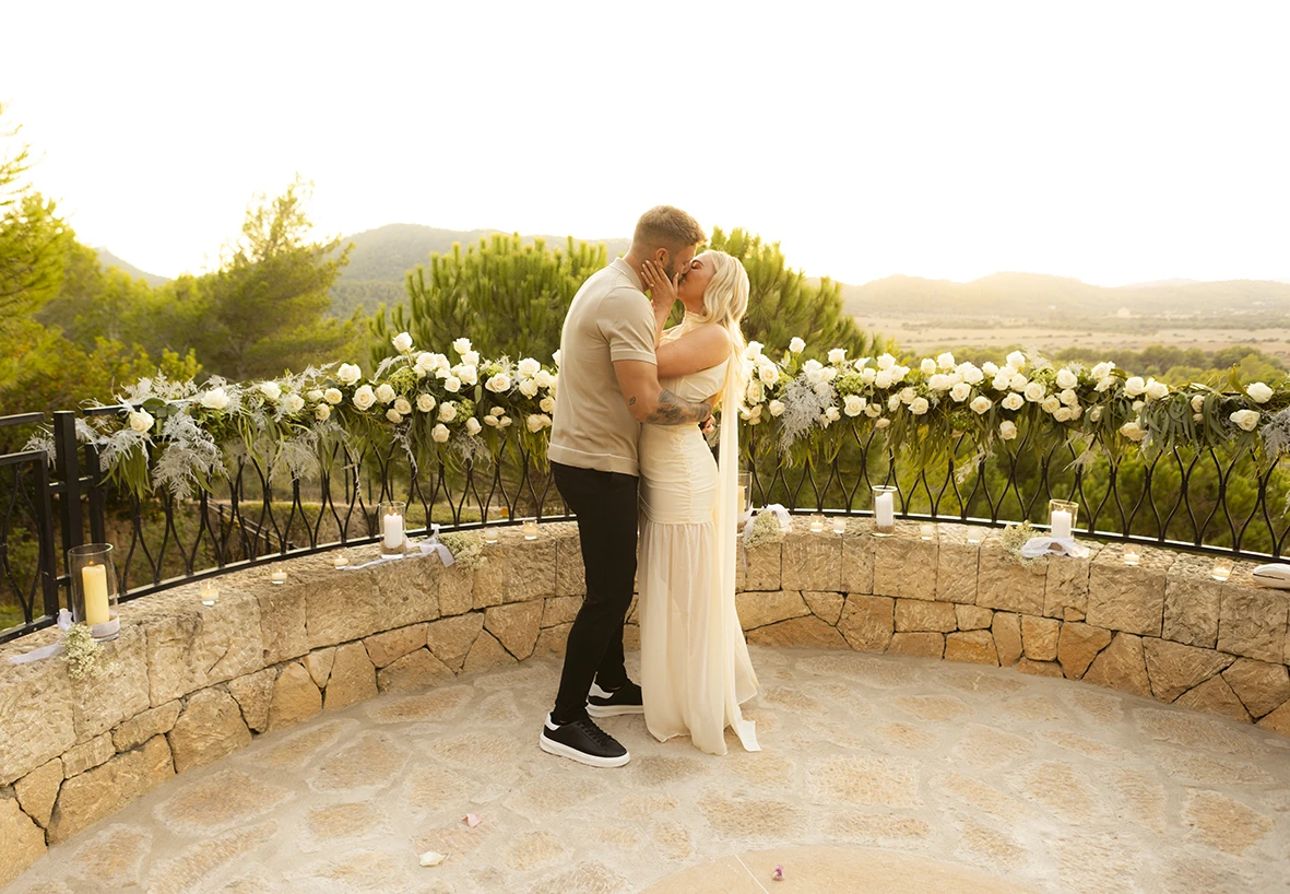 Emotional hug after a romantic proposal in Mallorca.
