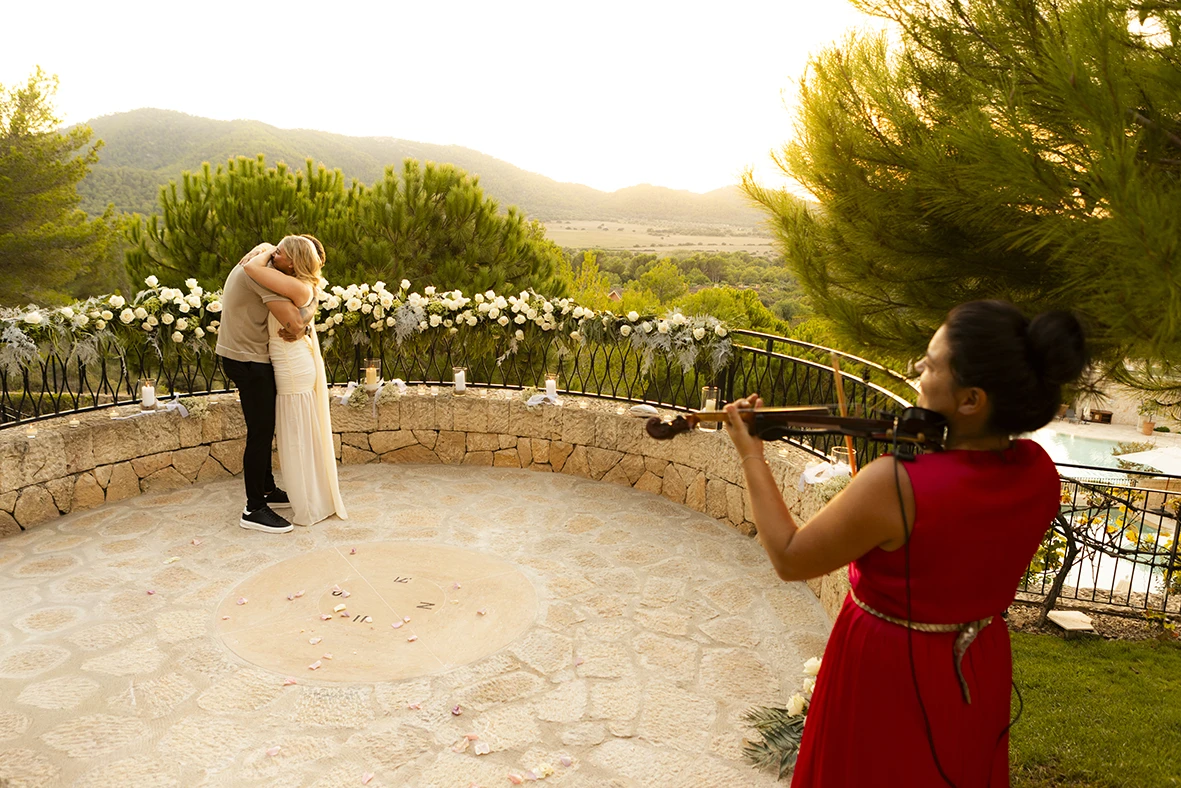 Romantic proposal in Mallorca with live violin music at sunset.