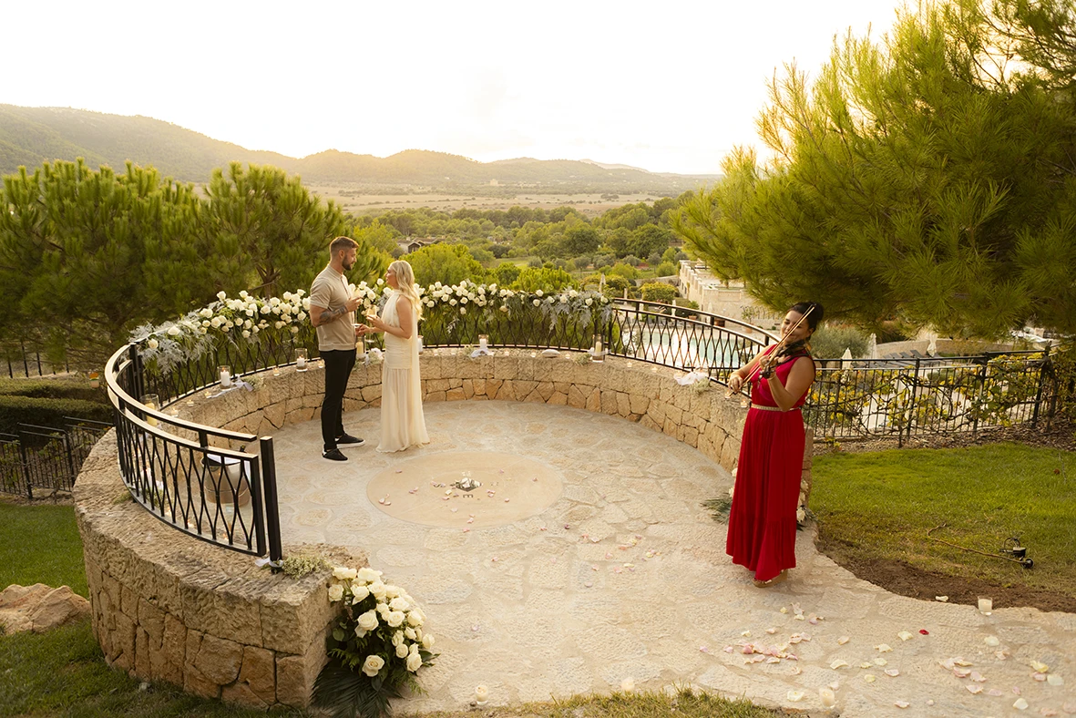 Proposal in Mallorca with violin music at sunset.