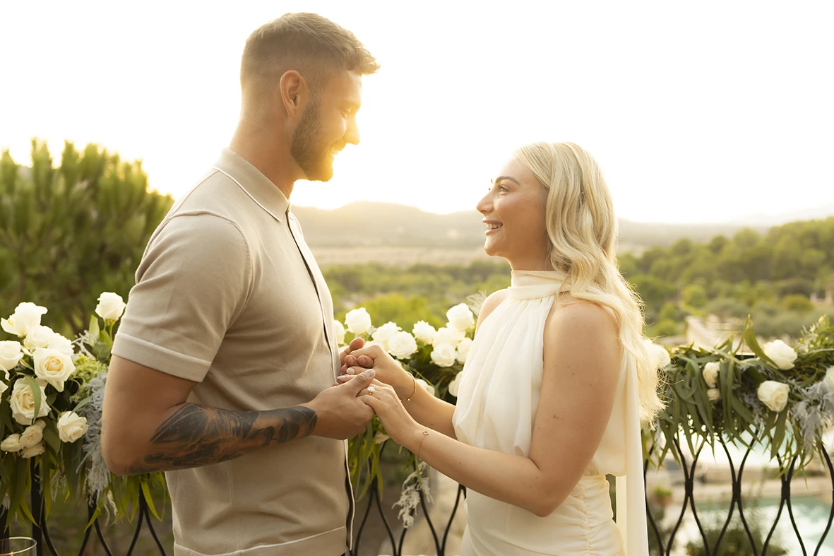 Couple holding hands during their engagement in Mallorca.