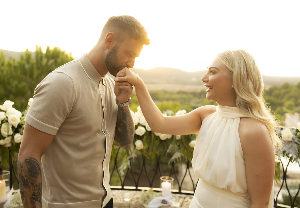 Groom-to-be kissing his fiancée’s hand during a proposal in Mallorca.