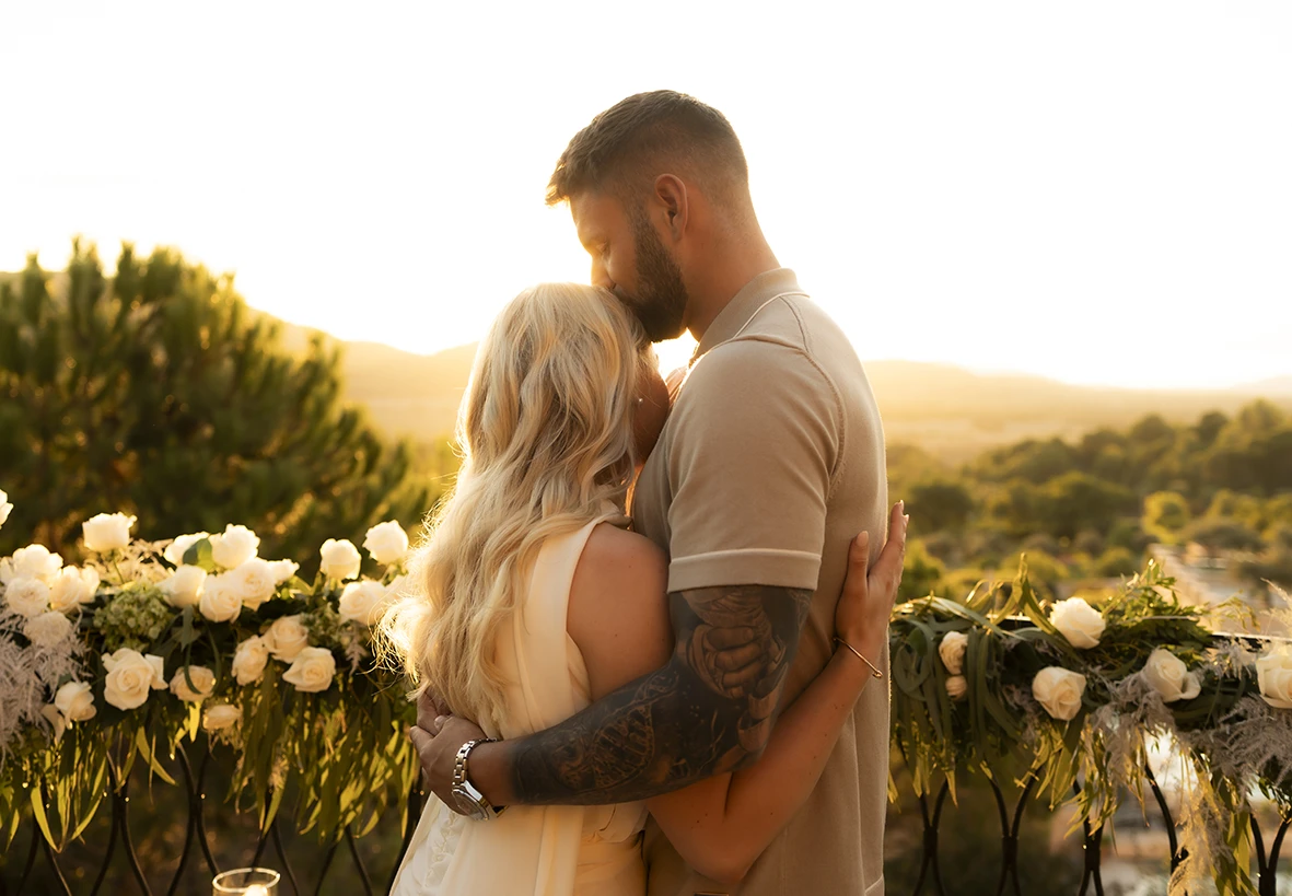 Couple embracing at sunset after a proposal in Mallorca.