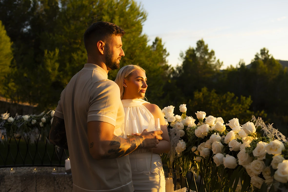 Couple watching the sunset after their proposal in Mallorca.