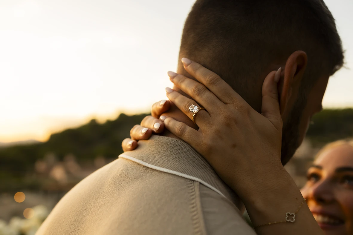 Engagement ring close-up while hugging after proposal in Mallorca.