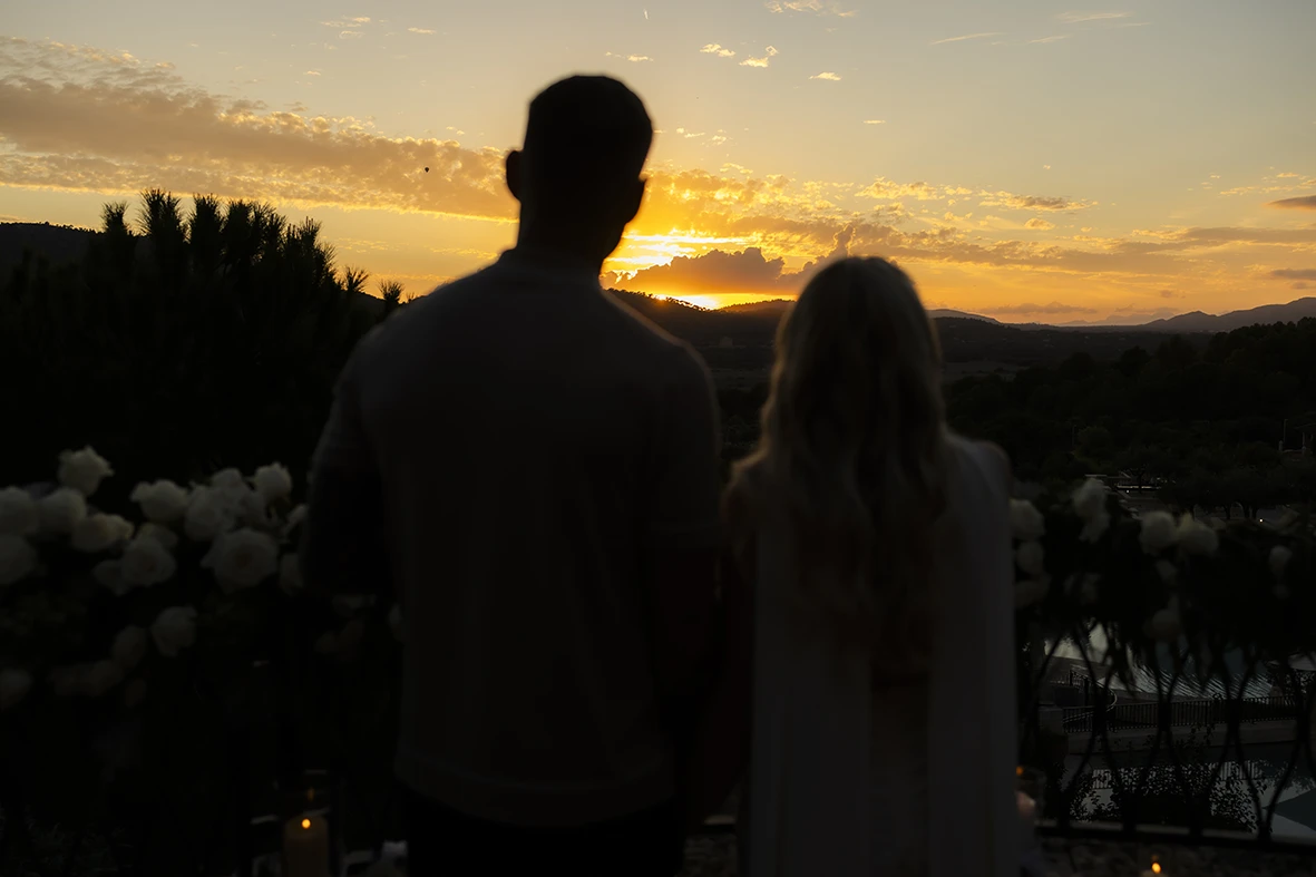 Couple watching the sunset after their proposal in Mallorca.