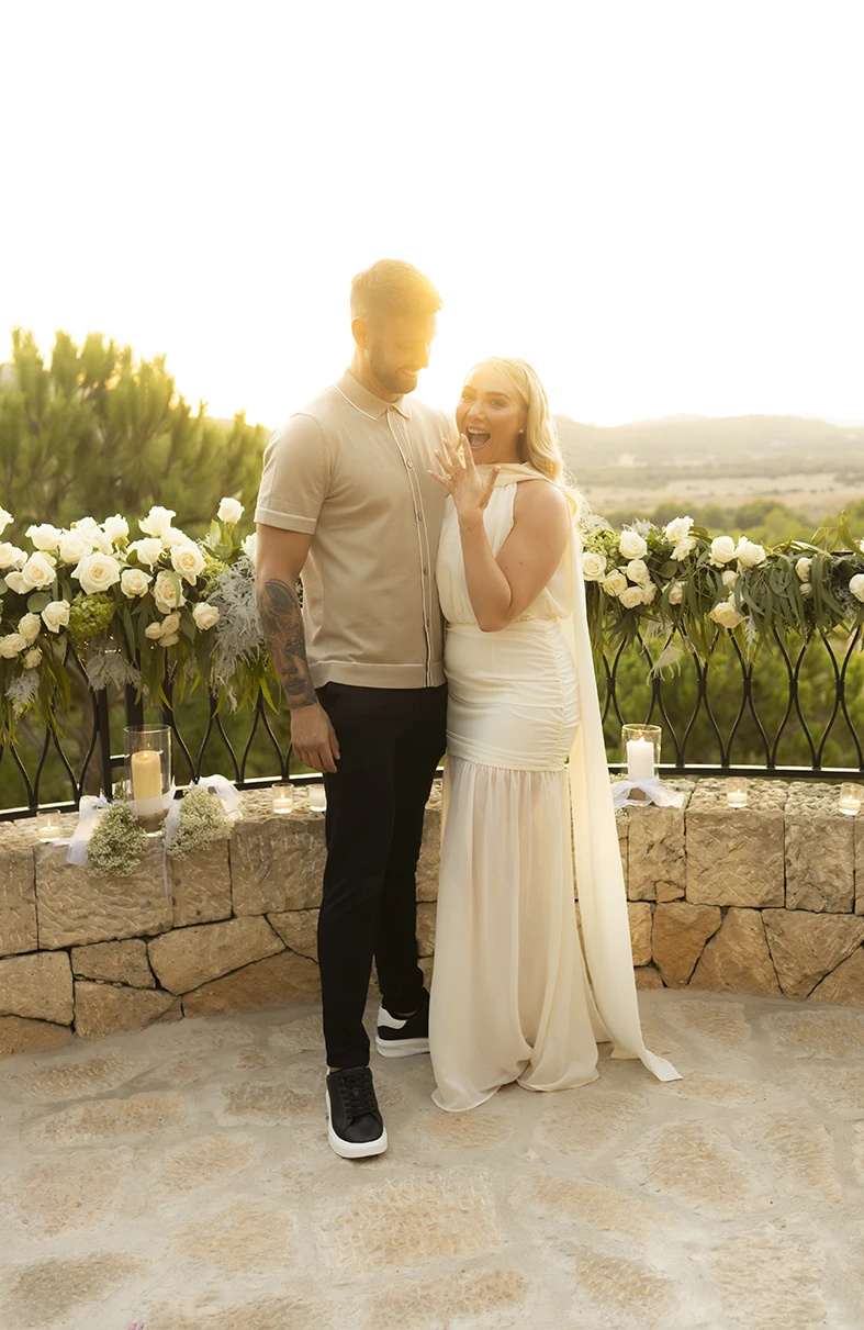 Engaged couple posing together after their proposal in Mallorca.