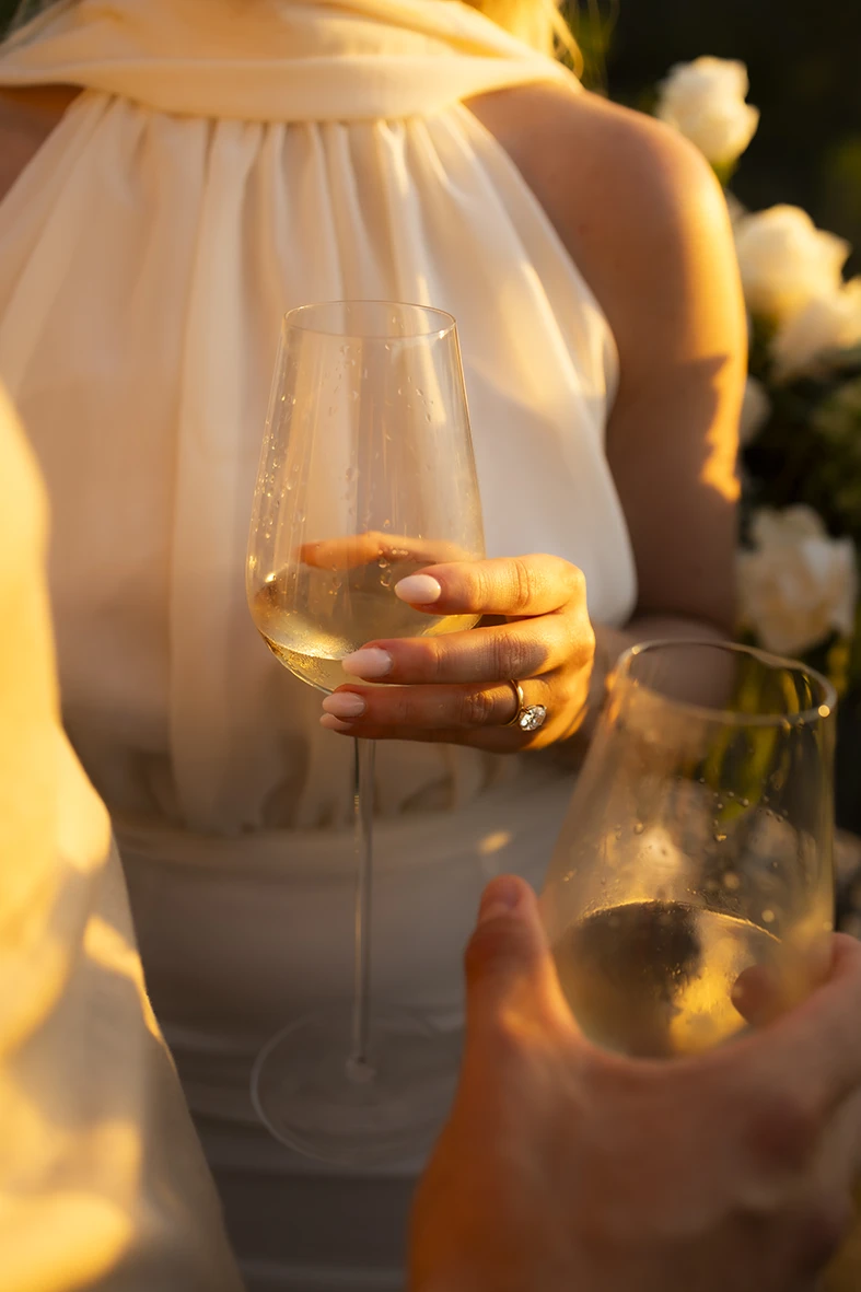 Engagement ring detail while holding a glass of champagne in Mallorca.