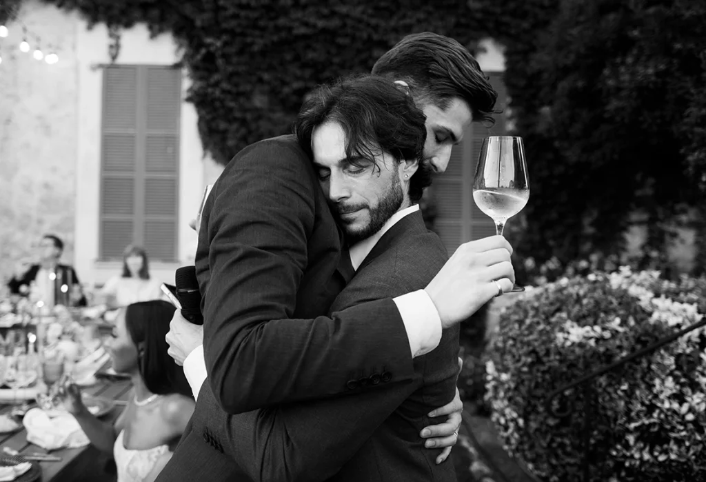 emotional grooms hugging during wedding in Mallorca black and white