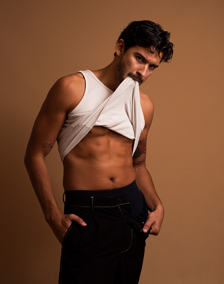 male model posing shirtless in studio