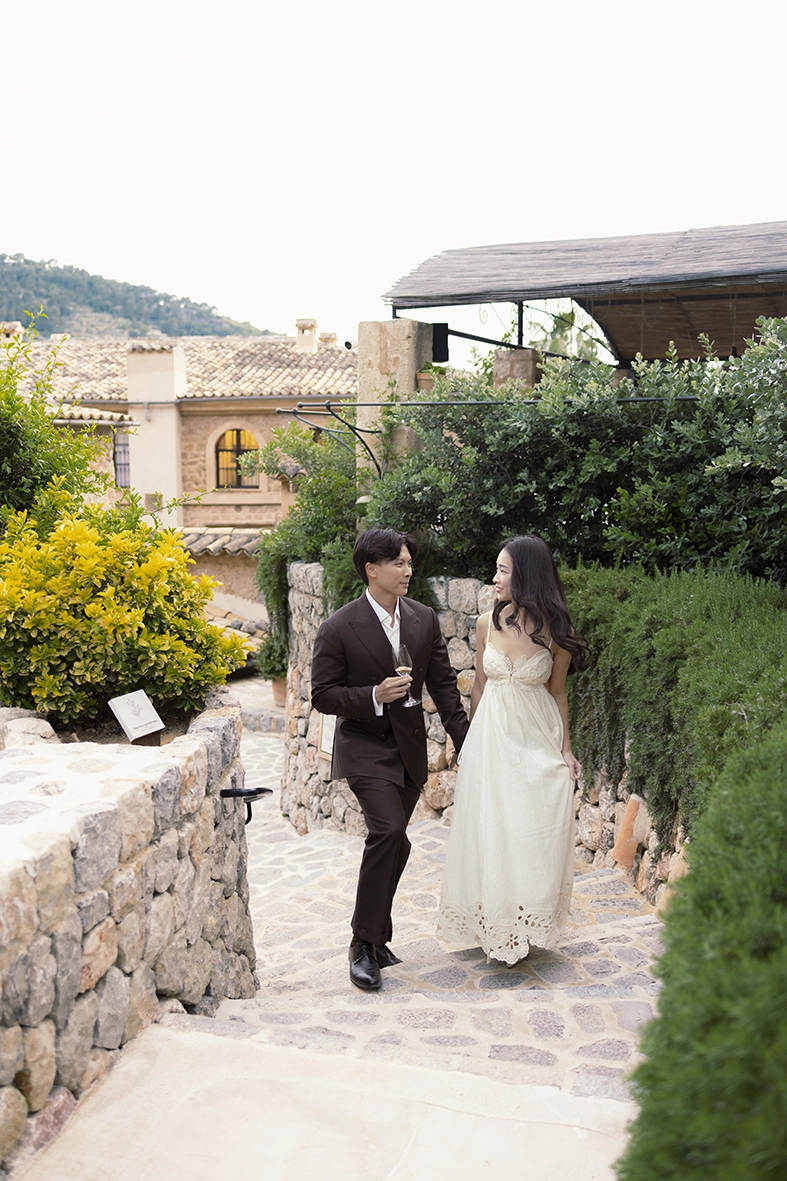 Couple walking through the gardens during a marriage proposal at Belmond La Residencia Deià