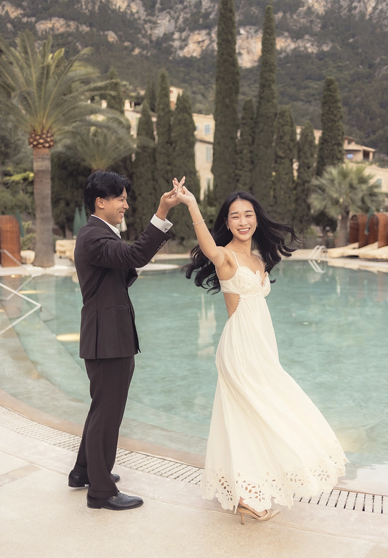 Joyful couple dancing by the pool after a marriage proposal at Belmond La Residencia Deià