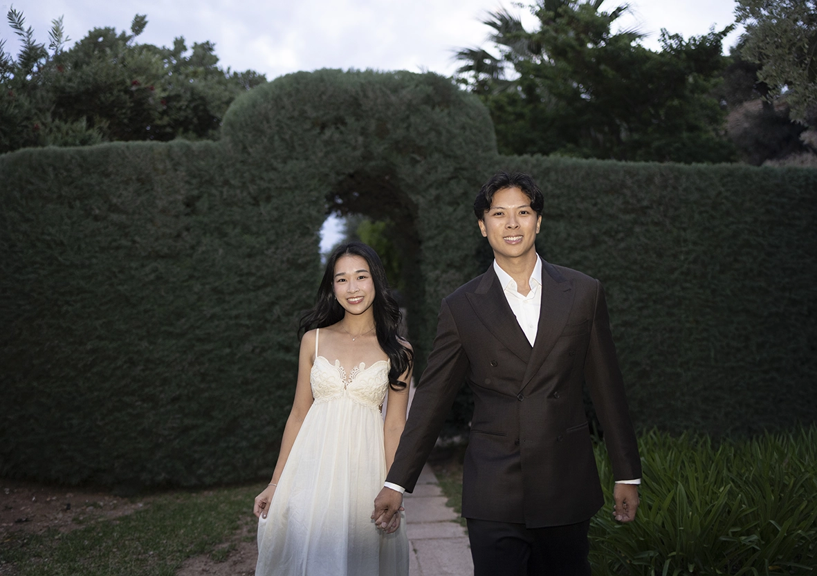 Elegant couple walking hand in hand after a marriage proposal at Belmond La Residencia Deià