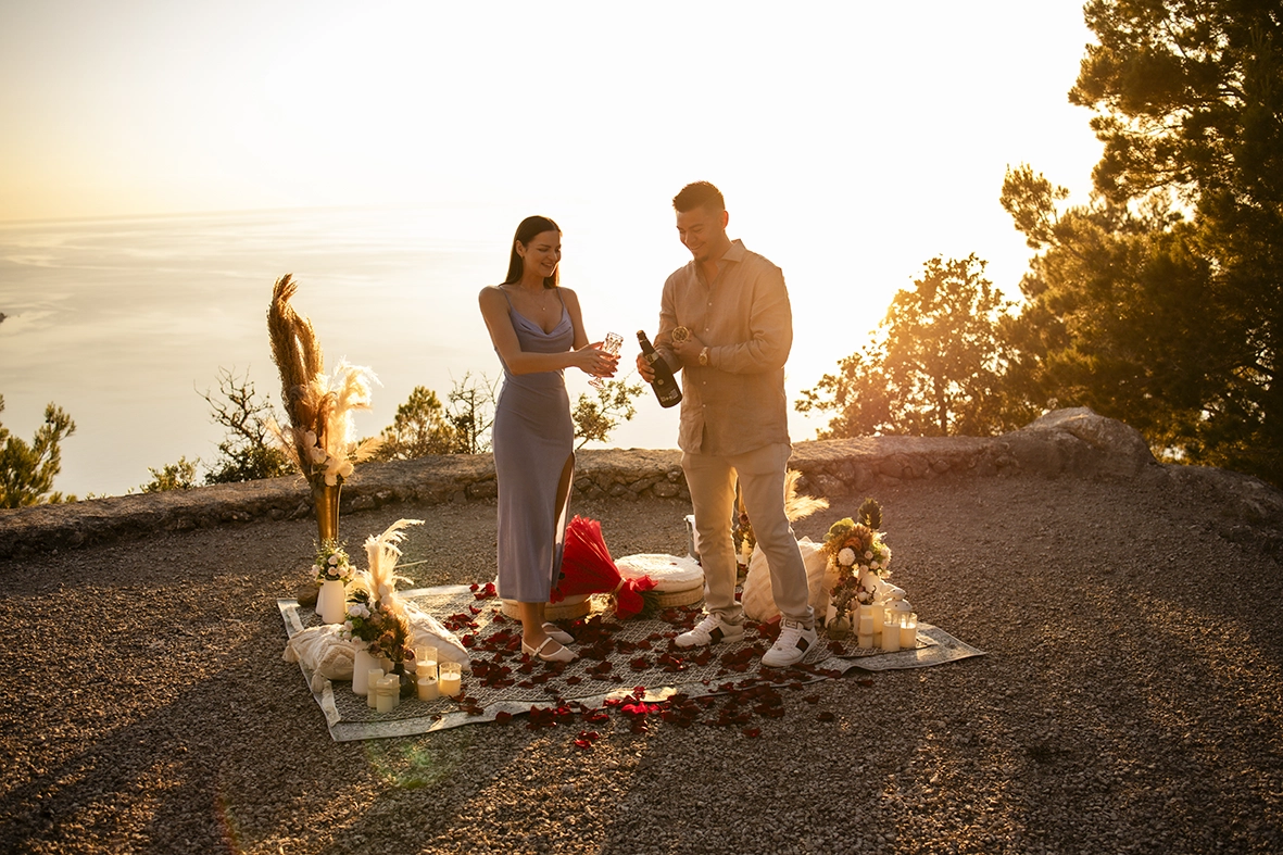 David y Katie brindan con champán mientras celebran su compromiso durante una romántica puesta de sol en Mallorca.