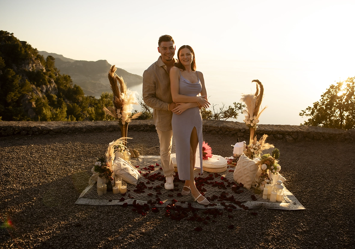 David and Katie embracing after their engagement with breathtaking sea views in Mallorca at sunset.