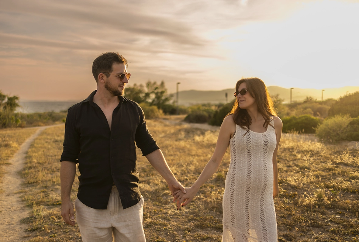 Couple walking hand in hand at sunset in Mallorca.