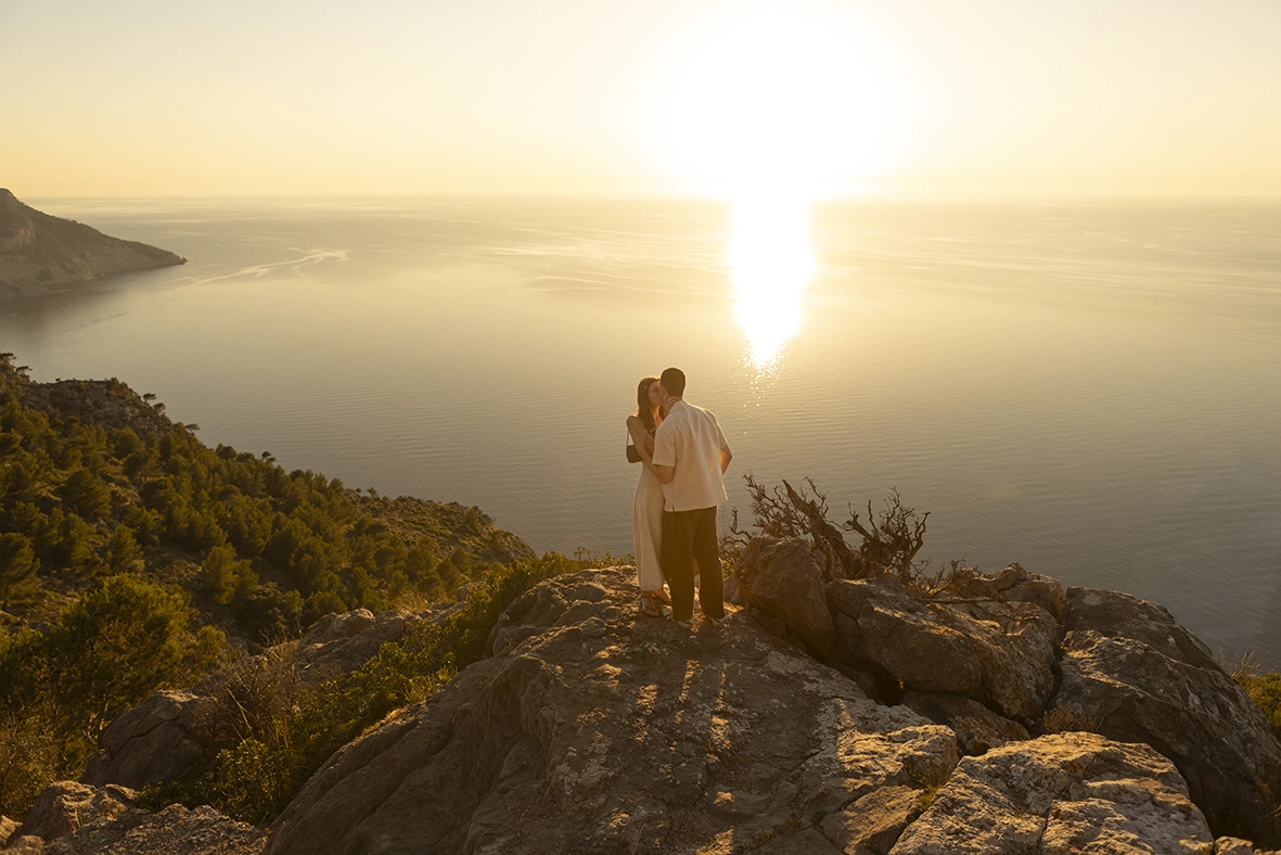 Recently engaged couple embracing at sunset during an engagement photoshoot in Mallorca