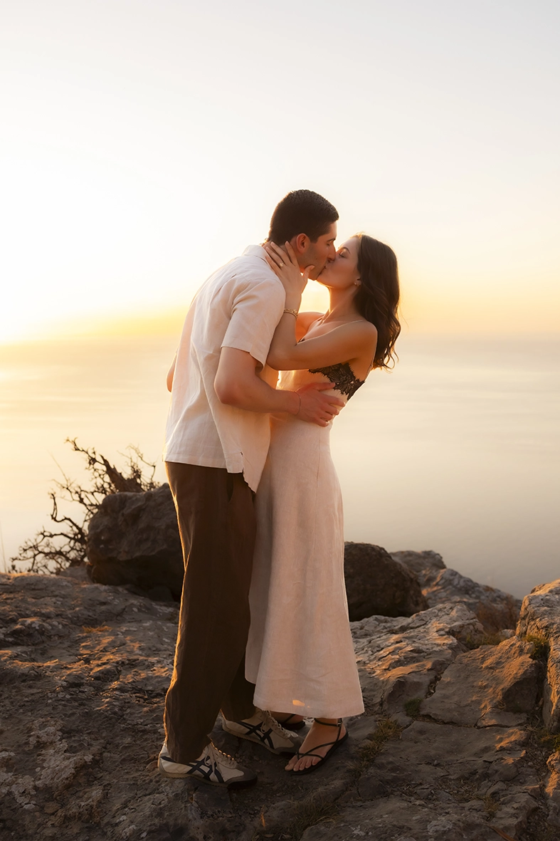 Romantic kiss after a surprise proposal captured by an engagement photographer in Mallorca