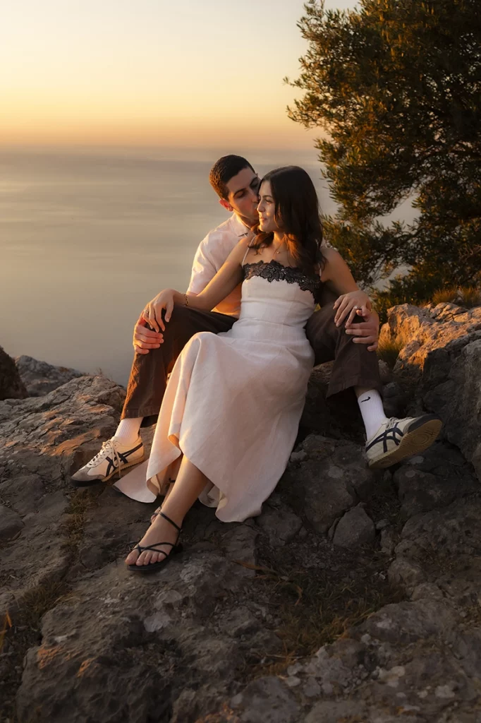 Engaged couple relaxing at sunset during an engagement photoshoot in Mallorca