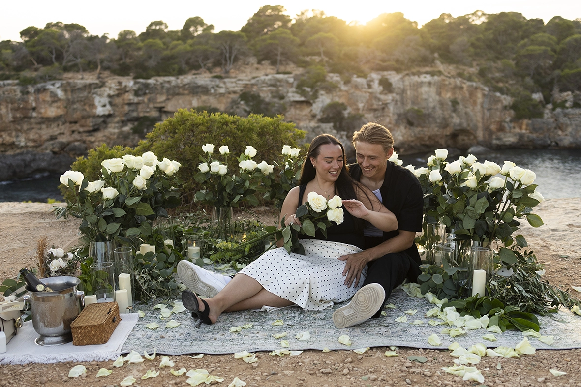 Couple enjoying a quiet moment after their proposal at one of the best places to propose in Mallorca. Photo by Inma del Valle.