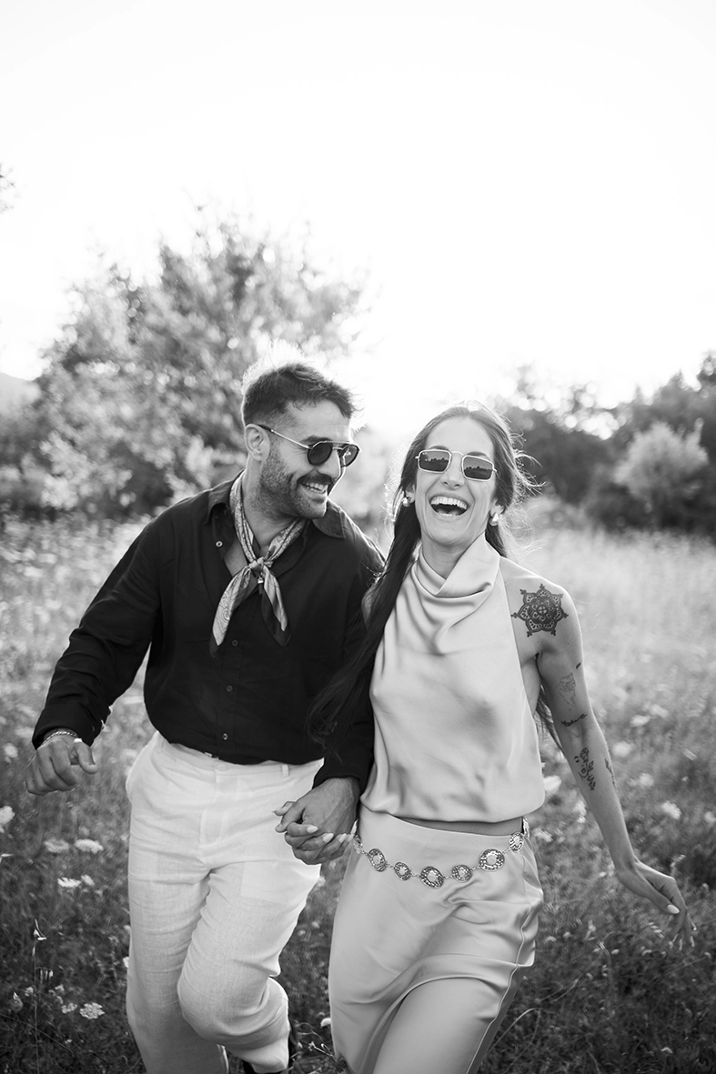 Anto and Biel walking and laughing together during their pre-wedding session in Mallorca.