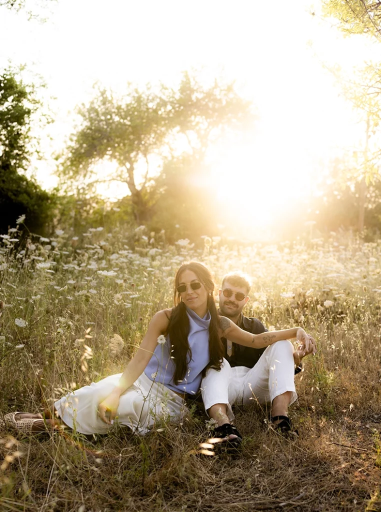 Anto y Biel sentados en el campo al atardecer durante su sesión de preboda en Mallorca.