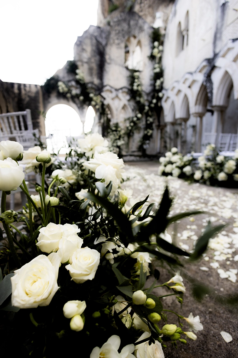 White floral wedding decorations in the historic cloister of Anantara Convento di Amalfi.