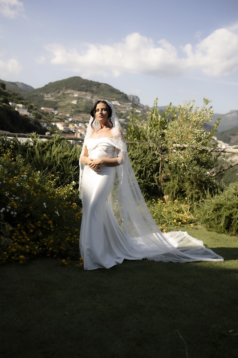 Bride wearing an elegant white gown and lace veil in a Mediterranean garden, photographed by a wedding photographer on the Amalfi Coast.