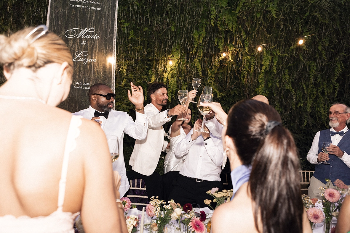 Bride dancing with her guests during an outdoor evening wedding reception on the Amalfi Coast.
