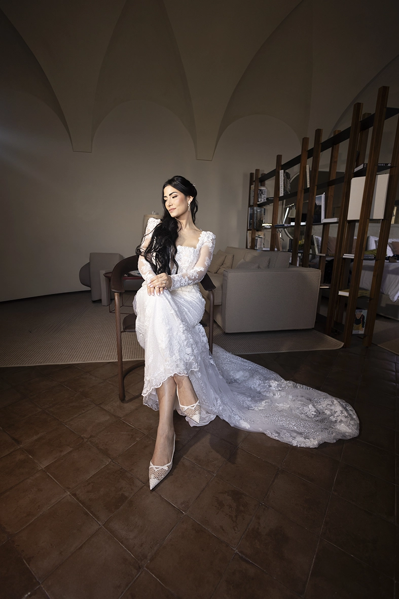 Bride walking through her room with her veil flowing before her Amalfi Coast wedding.